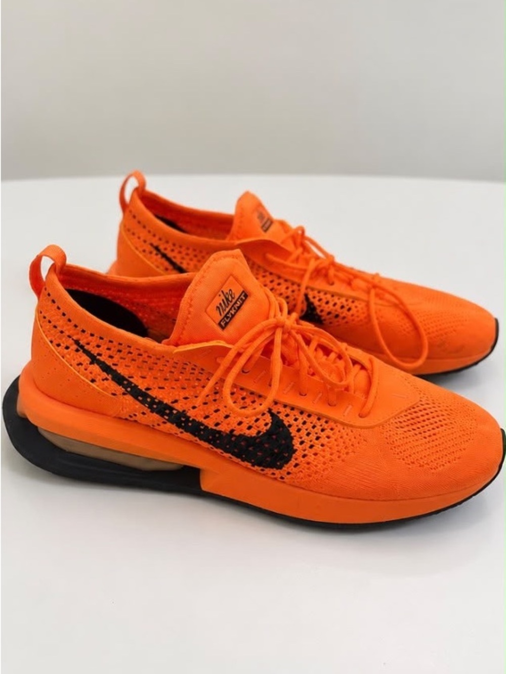 Nike Men’s Bright Orange Flyknit Sneakers with Black Swoosh